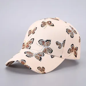 Beige baseball cap with brown butterfly print featuring a curved brim and classic 6-panel design