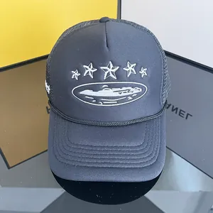 Detail view of the breathable mesh trucker hat featuring star embroidery and curved brim