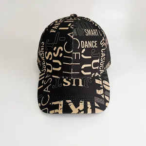 Detail of black baseball cap featuring beige all-over letter print and curved brim style