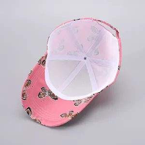 Detailed interior of pink baseball cap with breathable mesh and butterfly pattern