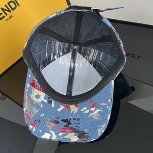 Detail view of denim graffiti baseball cap with internal sweatband and adjustable buckle