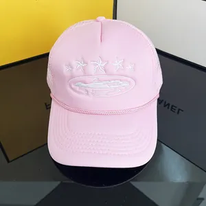 Detail of light pink trucker hat with star embroidery and breathable mesh back panel