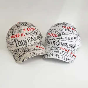 Graffiti print baseball caps in beige and white with street style letter patterns