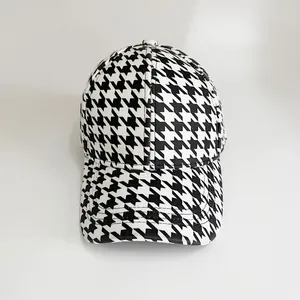 Close-up of the classic black and white houndstooth pattern on a baseball cap fabric