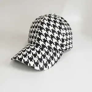 Close-up of classic black and white houndstooth pattern on a 6-panel baseball cap