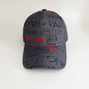 Detailed top view of grey baseball cap with red and black graffiti style lettering