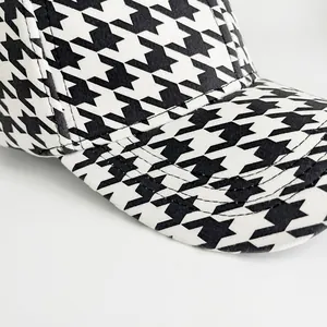 Close-up of the black and white houndstooth pattern and stitching on this stylish baseball cap