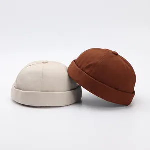 Detalle de gorros docker minimalistas en beige y marrón con costuras de alta calidad