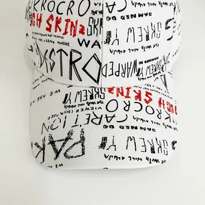 Close-up of white baseball cap with punk graffiti print and flat brim street style