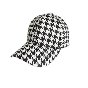 Classic black and white houndstooth pattern baseball cap with a curved brim for women