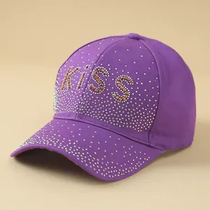Detailed view of shimmering purple baseball cap featuring crystal rhinestones KISS logo
