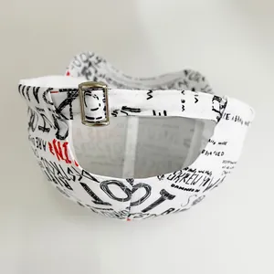Macro shot of white cotton baseball cap back with metal buckle and graffiti print