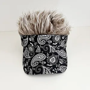 Detail of paisley print baseball cap with fuzzy synthetic hair tuft on top