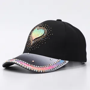 Macro view of a black baseball cap with rhinestone heart and gradient crystal brim