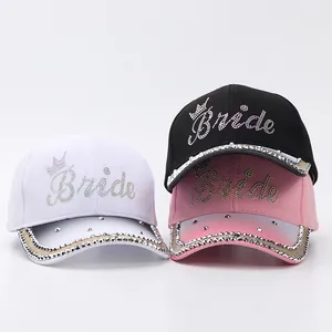 Close-up of rhinestone Bride letters and silver studs on sparkling baseball caps