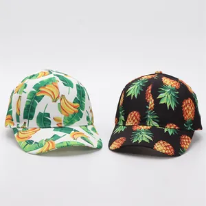 Detailed view of summer baseball caps featuring banana and pineapple botanical prints