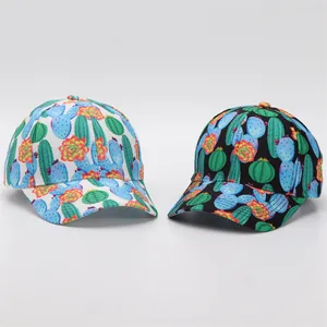 Detail of printed baseball caps showing cactus and floral patterns on black and white canvas