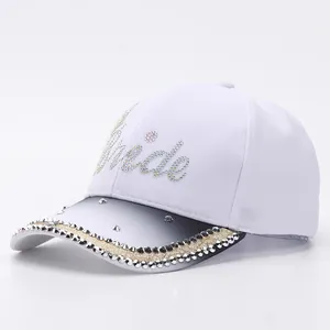 Detailed macro of white Bride baseball cap with rhinestones and gradient visor