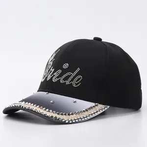 Detail of rhinestone 'Bride' lettering and gradient brim on a black baseball cap