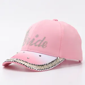 Close-up of pink gradient baseball cap with rhinestone Bride text and glitter brim