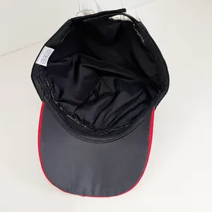 Internal detail of the baseball cap featuring 100 percent cotton label and red trim