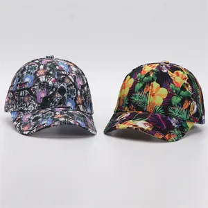 Detail view of two baseball caps with tropical floral and abstract galaxy digital prints