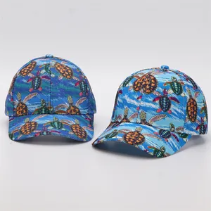 Detail of digital turtle print baseball caps with curved brim in vibrant blue ocean colors