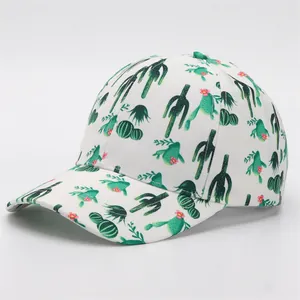 Detail view of white baseball cap with green cactus and pink flower prints on the brim