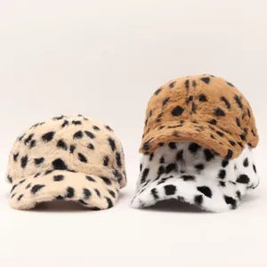 Close-up of three leopard print faux fur baseball caps showing soft texture and patterns