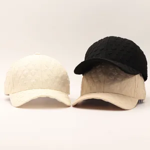Detailed view of seersucker baseball caps showing embossed 3D textures in three colors
