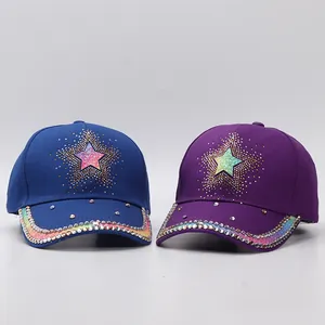 Detailed view of rhinestones and star pattern on blue and purple baseball caps
