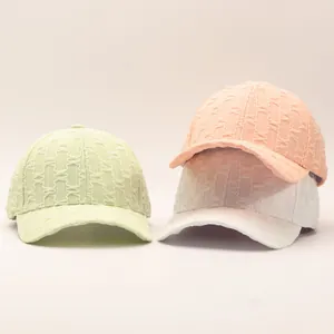 Detail shot of fairy style seersucker baseball caps in mint, peach, and white colors