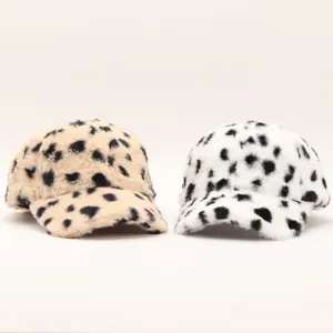 Detailed comparison of plush leopard and polka dot baseball caps in soft faux fur material