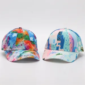 Detail showing two digital print baseball caps with colorful floral and abstract patterns