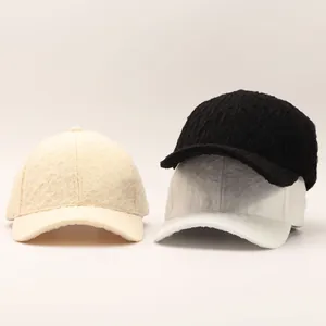 Detailed view of seersucker baseball caps showing textured fabric in beige, white and black