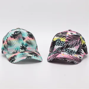 Detail of tropical palm leaf and leopard print baseball caps with digital floral patterns