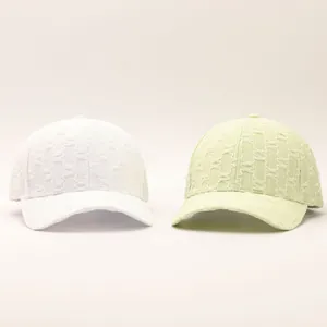 Detail of seersucker baseball caps showing textured fabric in white and light green colors