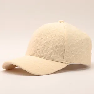 Detail of beige seersucker baseball cap showing textured bubble fabric and curved brim