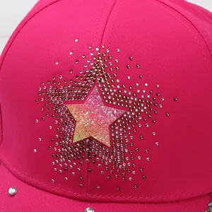Macro shot of gradient rhinestones and iridescent star on rose red baseball cap