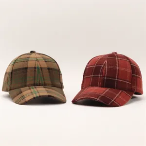 Close-up of thick houndstooth wool fabric texture on classic plaid baseball caps