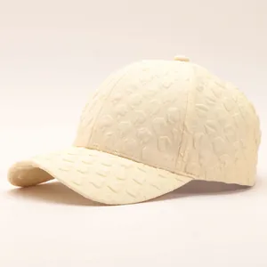 Close-up of beige seersucker baseball cap showing detailed 3D embossed bubble texture