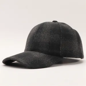 Close-up of charcoal grey wool-textured baseball cap showing fabric weave and curved brim