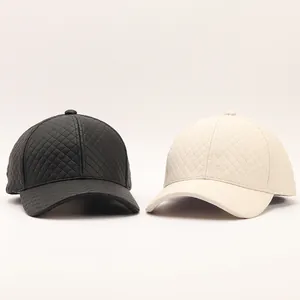 Detailed close-up of black and beige quilted PU leather baseball caps with diamond pattern