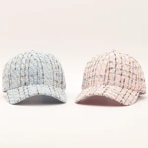 Close-up of pink and blue tweed baseball caps with premium woven fabric texture