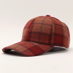 Close-up of red and brown houndstooth pattern on warm woolen baseball cap texture
