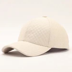 Quilted cream PU leather baseball cap with diamond pattern and curved brim in side view