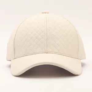 Close-up of cream PU leather baseball cap featuring detailed diamond quilted stitching