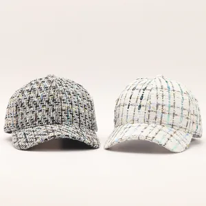 Close-up of the textured tweed weave and pattern on blue and white baseball caps