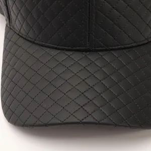 Detailed macro view showing the quilted texture of a black PU leather baseball cap