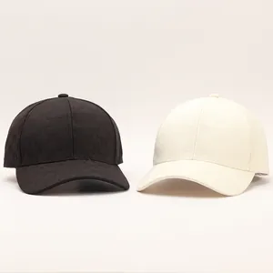Detailed view of black and cream baseball caps featuring embossed geometric M patterns